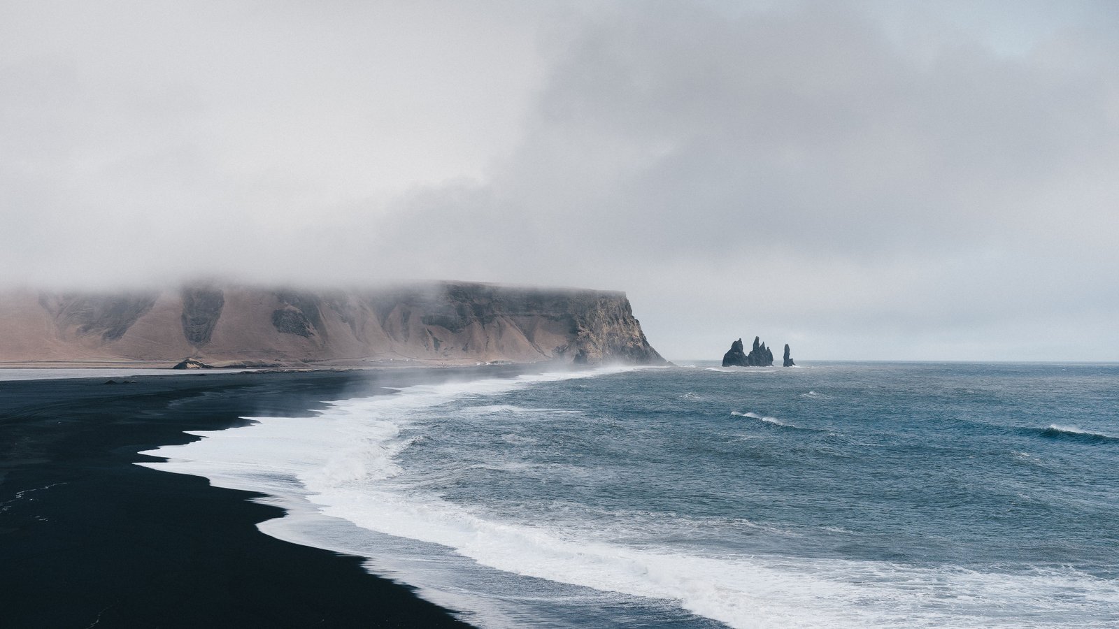 Waves washing a black sand beach